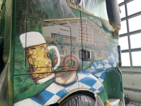 Airbrush-Sattelschlepper es wurde ein Führerhaus grün geairbrusht in blau-weiss und brauntönen es wurde ein Zelt und ein Maßkrug sowie eine Breze auf die Seitentür geairbrush