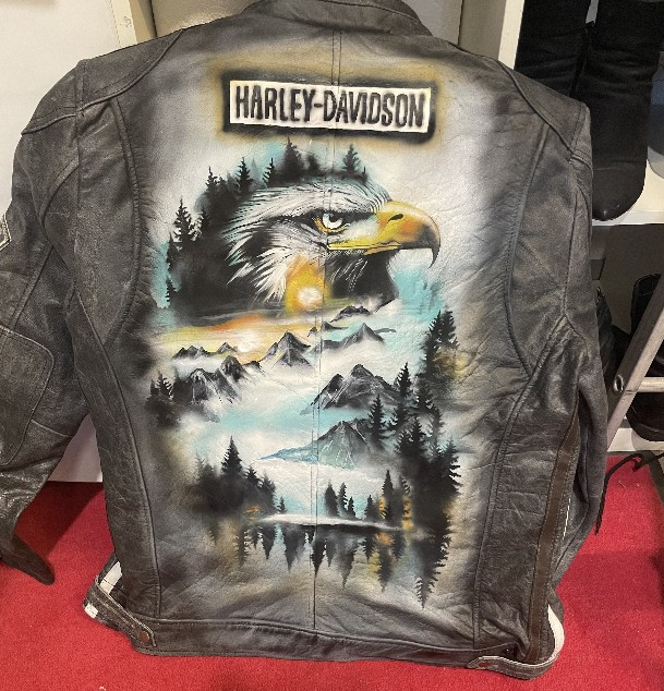Airbrush-Lederjacke auf einer schwarzen Lederjacke wurde ein Adler in brauntönen gearibrusht und bemalt